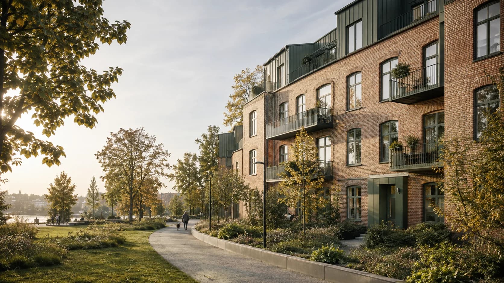 Ett nordiskt bostadskvarter där äldre tegel möter varsamt tillagd modern arkitektur